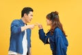 Photo of irritated aggressive couple man and woman screaming at each other while standing face to face isolated over yellow