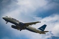 Photo of a Jetblue airplane on sky background blue and clouds