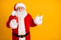 Photo of jolly holly fat santa claus use smartphone point finger copyspace follow x-mas christmas eve adverts discount Royalty Free Stock Photo