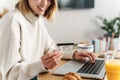 Photo of joyful attractive woman holding credit card and using laptop Royalty Free Stock Photo