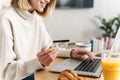 Photo of joyful attractive woman holding credit card and using laptop Royalty Free Stock Photo