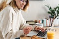 Photo of joyful attractive woman holding credit card and using laptop Royalty Free Stock Photo