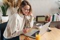 Photo of joyful blonde woman holding credit card and using laptop Royalty Free Stock Photo