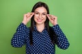 Photo of joyful brunette hairdo sweet lady hands spectacles wear blue shirt isolated on green color background