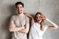 Photo of joyful caucasian couple girl and guy in basic clothing