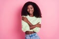 Photo of joyful charming afro american woman hug herself good mood isolated on pastel pink color background Royalty Free Stock Photo