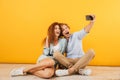 Photo of joyful couple handsome man and curly woman 20s sitting