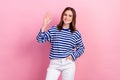 Photo of joyful cute pretty lady wear trendy sailor print clothes arm waving you hello friend isolated on pink color