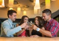 Photo of joyful friends in the bar communicating with each other