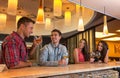 Photo of joyful friends in the bar communicating w Royalty Free Stock Photo