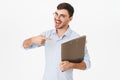 Photo of joyful handsome man holding and pointing finger at file