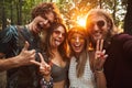 Photo of joyful hippie people men and women, smiling and taking Royalty Free Stock Photo