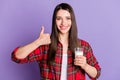Photo of joyful long hairdo millennial lady show thumb up hold milk wear red shirt isolated on violet color background