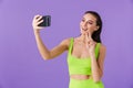 Photo of joyful young woman taking selfie photo on smartphone