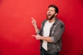 Photo of joyous man in casual clothing bursting in laughter and