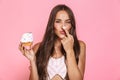 Photo of joyous woman 20s wearing dress having fun while eating