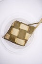 photo of a ketupat on a plastic plate, photographed from above