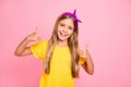 Photo of kind nice cute friendly girl showing you thumb up to give you nice feedback while with pink background