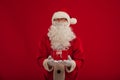 Photo of kind Santa Claus giving xmas present and looking at cam Royalty Free Stock Photo