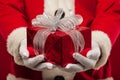 Photo of kind Santa Claus giving xmas present and looking at cam Royalty Free Stock Photo