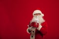 Photo of kind Santa Claus giving xmas present and looking at cam Royalty Free Stock Photo