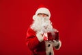 Photo of kind Santa Claus giving xmas present and Royalty Free Stock Photo