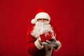 Photo of kind Santa Claus giving xmas present and Royalty Free Stock Photo