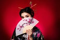 Photo of korean shy cute lady cover face traditional japanese culture theme festival on red color background