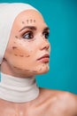 Photo of lady plastic surgery patient with correction marks look on cyan color empty space