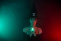 Photo of lady warlock performing occultism using gemstone pendant isolated on teal red color background