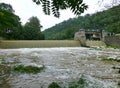 Large amounts of muddy water fowing over the weir