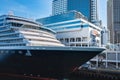 Photo of large cruiser ship docked in deep blue water in Vancouver port BC. Luxury Cruise ship in Vancouver harbour