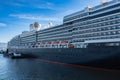 Photo of large cruiser ship docked in deep blue water in Vancouver port BC. Luxury Cruise ship in Vancouver harbour