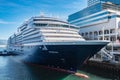 Photo of large cruiser ship docked in deep blue water in Vancouver port BC. Luxury Cruise ship in Vancouver harbour