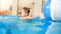 Portrait of laughing and smiling 3 years old little boy swimming with inflatable colorful ring and playing with beach Royalty Free Stock Photo