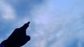 photo of left hand pointing towards the sky.