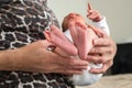 Grandmother holds her newborn granddaughter in her arms