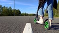 The legs of a woman on a scooter on a road Royalty Free Stock Photo