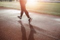 Sports ground. Legs working on a treadmill at sunset. the concept of a healthy lifestyle Royalty Free Stock Photo