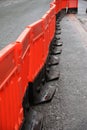 Photo of a line of plastic orange safety barriers