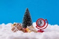 Photo of little clock toy show soon will be christmas midnight santa claus deliver yellow brown gift boxes stand near Royalty Free Stock Photo