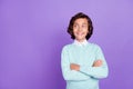 Photo of little cute brunet boy crossed arms look empty space wear blue sweater isolated on purple background Royalty Free Stock Photo