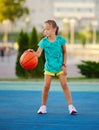 Photo of little cute girl playing basketball outdoors Royalty Free Stock Photo