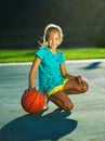 Photo of little cute girl playing basketball outdoors Royalty Free Stock Photo