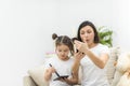 Photo of little daughter helping her young mother with the make up. Royalty Free Stock Photo