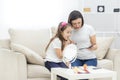 Photo of little daughter helping her young mother with the make up. Royalty Free Stock Photo