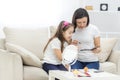 Photo of little daughter helping her young mother with the make up. Royalty Free Stock Photo