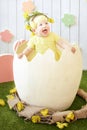 Little girl in yellow dress with decoration in her hair at the e