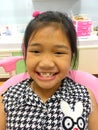 A little girl with heavy cross bite condition which is a type of oral misalignment is showing her teeth to the dentist. Pranburi, Royalty Free Stock Photo