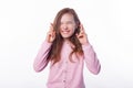 Photo of little girl standing over white background and making a wish with crossed fingers Royalty Free Stock Photo